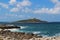 Island in the blue sea near the coast under blue sky, Isola delle Femmine, Sicily, Italy