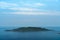 an island in the distance in the sea, blue sky with clouds, beautiful scenery in Montenegro, Adriatic Sea, tourism and travel