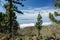 Island of La Gomera, soaring over the horizon, partly covered by the clouds. Bright blue sky. Traces of recent fire are visible on