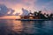 Island luxury Maldives sunset, tranquil lagoon, and overwater villa paradise