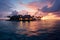 Island luxury Maldives sunset, tranquil lagoon, and overwater villa paradise