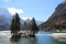 Island with many firs on the alpine lake called Lago del Predil