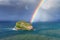 Island named Aketxe in Bermeo with stormy clouds and a rainbow