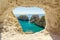 Island of Ponza, Italy. August 16th, 2017. An amazing view of three rocks in the sea, through an opening in the cliff. Framed