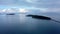 island in sea. Wonderful drone view of green tropical island in middle of calm blue sea
