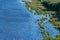 Island seacoast, aerial top view. Pure, clean and calm blue water. Virgin nature. Densely green jungle peninsula, copy space