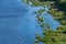 Island seacoast, aerial top view. Pure, clean and calm blue water. Virgin nature. Densely green jungle peninsula, copy space