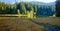 Island with trees in autumn colors with Chopok background. Vrbicke lake in Demanovska valley in Slovakia.