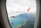 Island view through aircraft windows over the sea