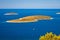 Islands in blue sea aerial view near Primosten archipelago