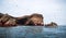 Islas Ballestas, Paracas, Peru-OCTOBER 15, 2017: Landscape of the rock. Group of tourists ride on a excursion boat.
