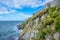 Isle of Man seashore landscape covered with green grass and great wall of Peel Castle in Peel city, Isle of Man