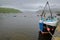 ISLE OF SKYE, UK - JUNE 18, 2017: View of Portree Bay from Portree Harbor with a commercial fishing boat in the foreground, Highla