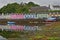 ISLE OF SKYE, UK - JUNE 19, 2017: View of Portree harbor with reflections and colorful houses, seen from the seashore, Highlands,