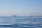 Isles of Scilly, United Kingdom - sailboat in the distance sailing though calm waters between rocks