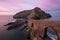 The islet San Juan de Gaztelugatxe and its medieval bridge with stairs during incredible pink sunset, Basque Country, Bermeo, Spai