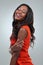 Isnt life beautiful. Studio shot of a beautiful young woman posing in a red dress against a gray background.