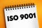 ISO 9001 - international standard that specifies requirements for a quality management system, text concept on notepad