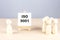 ISO 9001 text on easel with wooden figure, meeting concept