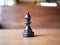 Isolate chess on wooden background, black knight.