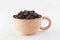 Isolate coffee beans in wood cup white background