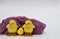 Isolate, copyspace. a family of yellow fluffy artificial chicks in a purple ruffled plaid on a white background bottom left.