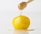 Isolate dripping organic honey with lemon on white background