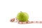 Isolate green apple on white bakcground with Measuring tape around. The heathy fruit for people who want to increase health up.
