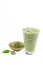 Isolate Iced Green Tea latte matcha on white background with crushed tea extract powder in wooden cup and leaves. The most