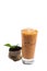 Isolate Iced Thai Tea glass cup with dried and fresh tea leaves.