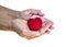 Isolate of red heart on dirty hands of old man,