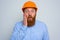 Isolated amazed architect with beard and orange helmet