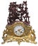 Isolated antique golden table clocks with statuette
