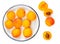 Isolated Apricot fruits on a plate. Apricot on white background. Sweet apricots with leafs closeup