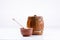 An isolated barrel on a white background. Wooden bowl for honey with a honey stick in a cup