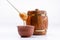 An isolated barrel on a white background. Wooden container for honey with honey stick