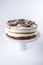 Isolated beautiful homemade layered sponge cake with white cream in rustic style