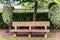 isolated bench cover with flowers at lush green park at morning from flat angle