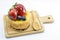 Isolated berries cheesecake on wood cutting board, berries sweet