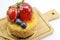 Isolated berries cheesecake on wood cutting board, berries sweet