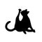 Isolated black silhouette of cat on white background. Flat cartoon cat licks paw