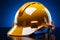 Isolated blue backdrop spotlights 3D rendered yellow safety helmet or hard cap