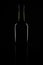 Isolated bordeaux wine bottle, dark background silhouette