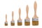 Isolated brushes. Five brushes of different sizes with wooden handles are isolated on a white background.