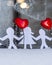Isolated Chain of Origami Paper Boys and Girls Holding Hands With a Red Heart Between Them and the Hoarfrost on Window in