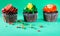 Isolated Chocolate Cupcakes with Green Background