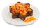 Isolated Christmas fruitcake on plate with dried apricot