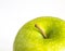 An isolated close up of a green waxed apple on a white background