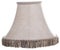 Isolated close up shot of a classic cut corner bell shaped beige tapered lamp shade with a brown fringe on a white  background