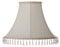 Isolated close up shot of a classic cut corner bell shaped white beige tapered lampshade with a beaded fringe on a white backgroun
